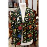 A richly embroidered 1940s jacket on red and yellow flowers and foliage (1)
