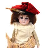 HEUBACH: A Heubach bisque head and leather bodied doll, neck marked with a horseshoe,