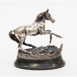 A silver horse sculpture on plinth "Startled Yearling" by John Pinder