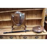 A Victorian brass bed-warmer with ebonised handle and a mahogany framed shield shaped toilet mirror