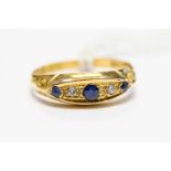 A Victorian sapphire and diamond boat head ring, set with three sapphires with diamond accents,
