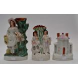 Three Victorian Staffordshire flatbacks to include; a house figure in the form of a money box,