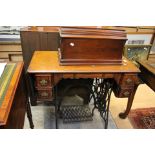 A Singer treadle sewing machine with four drawers, each with metal ornate handles in the table base,