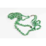 A jade bead necklace with diamond set torpedo clasp