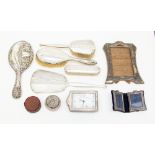 A collection of silver to include brush set and mirror, double photo frame, Sheffield 1989,