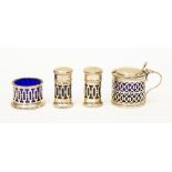 A four piece silver condiment group with blue liners,