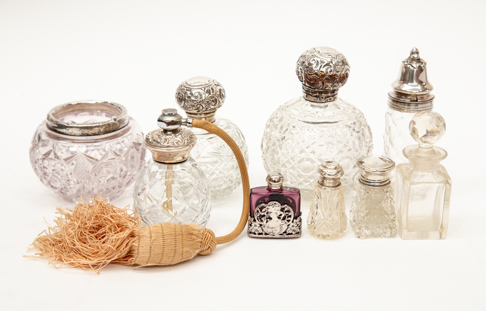 Two Edwardian cut glass silver topped perfume bottles,