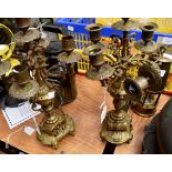 Pair of brass candelabra with four branch and centre candlestick with intricate detail,