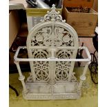 A late Victorian white painted cast iron umbrella stand, with a scrollwork frame,