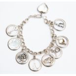 A silver Avon charm bracelet with open round charms including with various details to the centre