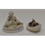 Ceramic clown head powder puff and statue of two sitting children