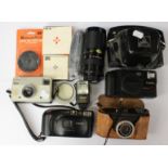 Quantity lot of cameras to include; two Canon and Vivitar lens,