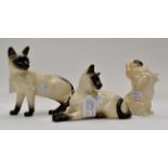 Two Royal Doulton Siamese cats with a Shih Tzu dog