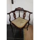 An Edwardian corner chair with lyre supprts.