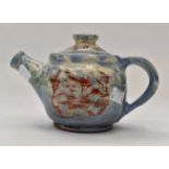 A Judith Trim teapot in a blue glaze,