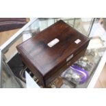 A Victorian rosewood sewing box, the interior cover with leather drop leaf compartments,