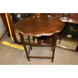 WITHDRAWN****An early 20th Century oak side table, with a wavy edged top,