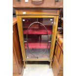 An Edwardian mahogany Sheraton style display cabinet, fitted with a single glazed door,