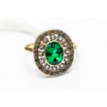 A green stone set dress ring, continental gold French, 18ct gold mark to exterior shank,