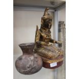 A Nat Worship figure Burmese in need of appeasement along side a North American Indian clay pot