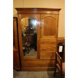 An Edwardian mahogany compactum wardrobe, fitted with a single full length mirrored door,