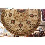 A contemporary machine made woollen rug, of oval form,