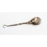 A silver elephant head miniature button hook,
