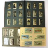 Two albums of 1920's cigarette cards, loosely inserted, subjects include sporting photographic,