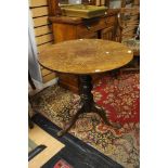 A 19th Century oak tilt top tripod table, circular plank form, turned column,