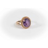An amethyst and 9 ct gold dress ring, the oval stone approx 11mm x 9mm, rope edge border, size M,