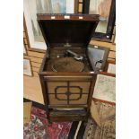 An early 20th century oak cased 'Academy' gramaphone with a selection of 78 records including two