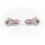 A pair of Art Deco diamond and ruby set clips, the stylised ribbon bow design,