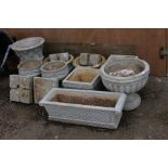 A collection and nine various concrete planters,