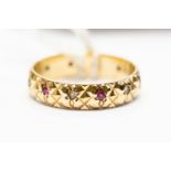 A stone set 9ct gold band, machine cut texture set with alternate ruby and white stones, size O,