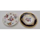 A Royal Crown Derby plate, painted in coloured enamels with a spray of flowers and leaves,