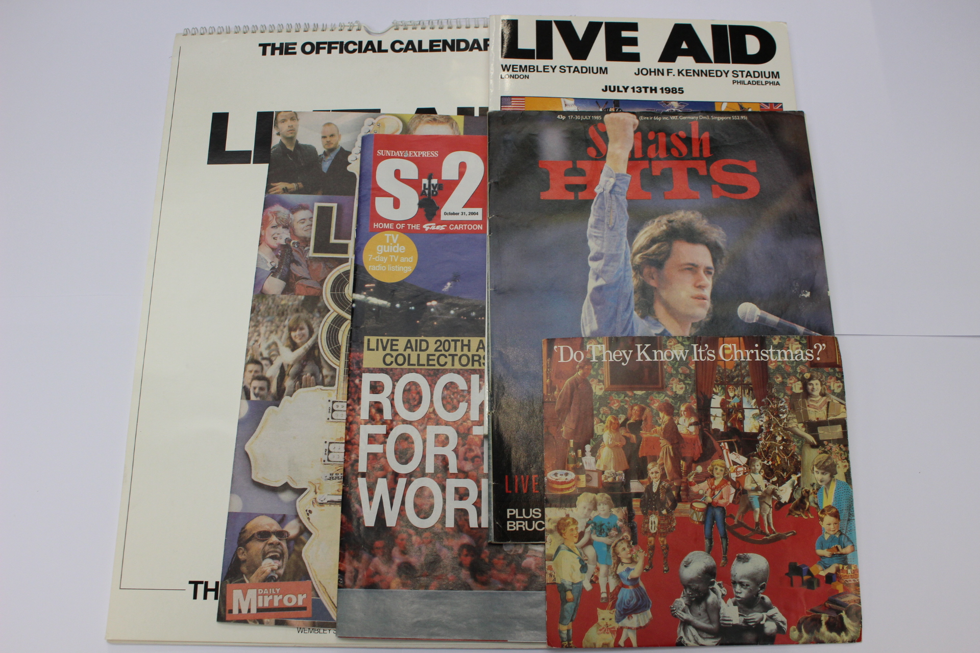 A collection of music memorabilia relating to LIVE AID, including Live Aid programme, calendar,