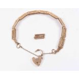 A 9ct rose gold gate bracelet with padlock clasp, spare link,