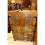 A mid -third quarter Twentieth Century oak hall cupboard with carved panelled front and heavy cast