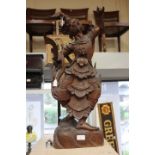 A 19th Century Japanese warrior figure, in a pose and carrying a sword, 75 cms high approx,