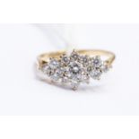 A cubic zirconia set cluster ring, elongated claw set detail, width approx 17mm, size N1/2,