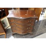 A Victorian mahogany serpentine chest of drawers in the Georgian manner.