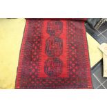 An early 20th century black and red hand knotted woollen rug
