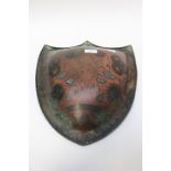 A Persian bronze domed shield chased engraved with foliate pattern, 36 x 42 cms approx,