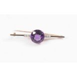 An amethyst and diamond set 18ct gold bar brooch, the central amethyst approximately 16mm diameter,