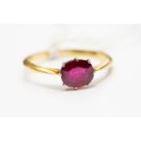 A synthetic ruby solitaire, the oval cut ruby approx 0.