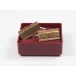 A pair of 9ct gold cufflinks, rectangular shape, polished centre with textured borders,