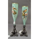 Two 20th Century glass flute vases raised on a dolphin base, enamelled glass,