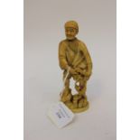 A Japanese ivory carving of a fisherman, circa 1868-1912 Meiji period, signed to base,