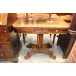 A mid Nineteenth Century rose mahogany, games card table having pedestal supprt with lions feet,