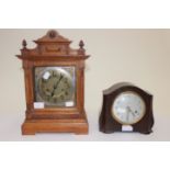 An oak cased brass faced mantle clock,